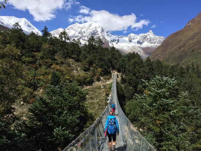 Crossing the suspension bridge of Manaslu trekking
